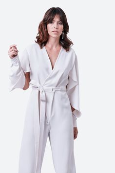 The minimalist white of our Junin jumpsuit belies its sophisticated structure, with elegantly slashed, deconstructed long sleeves creating a cape-like effect. The wrap-style design features a straight-leg silhouette, cinched at the waist with an extra-long belt. Just add statement earrings. Silk-cotton crepe Specialist clean Minimalist White, White Jumpsuit, The Minimalist, Style Design, Wrap Style, Extra Long, Statement Earrings, Design Features, Cape