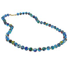 Add a touch of classic Venetian style to your outfit with this elegant Murano millefiori necklace. Centuries-old Murano glass technique perfected by Italian master craftsmen is used to create colorful mosaic effect that is fun and trendy, yet classic and timeless. This is a unique necklace that will add Venetian chic to your jewelry collection and will brighten up your look and your day. Measurements: Each necklace measures 24 inches in length and comes with an attractive velvet pouch and a cert Turquoise Round Glass Necklaces, Blue Round Glass Necklaces, Blue Glass Round Necklaces, Blue Single Strand Murano Glass Beaded Necklace, Elegant Blue Murano Glass Necklace, Blue Murano Glass Jewelry With Colorful Beads, Blue Murano Glass Single Strand Necklace, Blue Single Strand Murano Glass Necklace, Turquoise Single Strand Glass Necklace