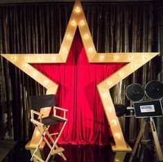 a star shaped stage set up with lights on it and a director's chair