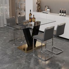 a glass dining table with two chairs and bottles on the counter top in front of it