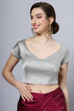 Our Satin Comfort Stretch collection blouses are made to impress and made to be worn all day. Made from the finest satin-cotton blend stretchable fabric, it holds its shape and shine while offering the comfort of stretchable material. Wear it with your favorite saree, as a crop top or lehenga choli! Item Type: Saree blouse / Crop top Product Features: Color: Silver Fabric: Satin Stretch Trim: Back Dori Neck Style: Leaf, Front & Back Sleeve Length: Short Sleeve Closure: Back Hook Padded: No Occas Leaf Cut Neckline Blouse, Leaf Shape Blouse Back Neck, Fitted Party Blouse In Solid Color, Elegant V-neck Blouse Piece, Elegant Fitted V-neck Blouse Piece, Solid Stretch Blouse For Formal Wear, Stretch Blouse For Formal Occasions, Formal Stretch Blouse, Formal Satin V-neck Top