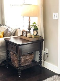 a living room with a couch, table and lamp on it's side by the window