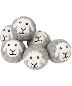 four gray and white sheep balls with faces on them