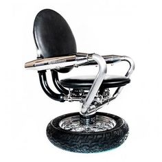 an image of a motorcycle seat on top of a wheelbarrow with chrome rims