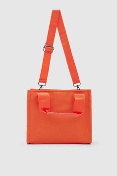 Introducing the "Canvas Fabric Orange Crossbody Bag" from Lunarity Garage – a vibrant and stylish accessory that combines the durability of canvas fabric with a pop of orange color. Crafted with meticulous attention to detail, this bag offers both fashion and functionality to suit your everyday needs. Make a bold statement with the Canvas Fabric Orange Crossbody Bag – a perfect blend of durability and trendiness. The vibrant orange color adds a touch of energy and excitement, making it a versati Functional Canvas Crossbody Bag For On-the-go, On-the-go Canvas Bag With Detachable Strap, Trendy Orange Large Capacity Satchel, Trendy Large Capacity Orange Satchel, Functional Crossbody Canvas Bag With Removable Pouch, Red Canvas Shoulder Bag With Zipper, Red Canvas Shoulder Bag With Zipper Closure, Functional Crossbody Canvas Bag, Functional Crossbody Canvas Bag For On-the-go