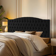 a black headboard on a bed in a bedroom