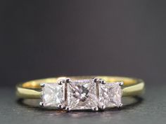 three stone diamond ring with yellow gold band