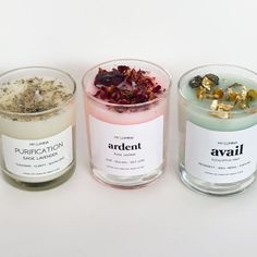 three different types of candles with labels on them