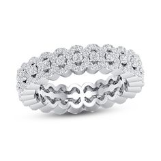 a white gold ring with round diamonds on the sides and two rows of wavy bands