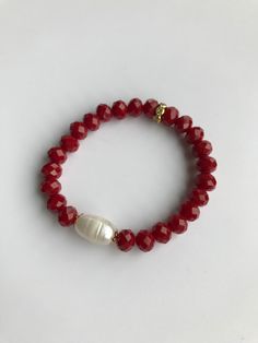 This Faceted Red bracelet is handmade with 7mm faceted bead, 10mm rice pearl and gold rhinestone embellishment. Modern design and is an ideal complement to make up a mix of chain or other stone bracelets. Gift Ready! CARE GUIDE: ~ Avoid applying hand lotions, sunscreen, and other chemicals while wearing your jewelry to prevent    discoloration. ~ Remove your bracelet before being exposed to saltwater, chlorine or any other chemicals, these can    deteriorate your bracelet. ~ Never over stretch t Faceted Round Beads Stretch Bracelet As Gift, Faceted Round Bead Stretch Bracelet Gift, Adjustable Red Pearl Bracelet Gift, Faceted Beads Stretch Bracelet Gift, Adjustable Red Pearl Bracelet As A Gift, Faceted Round Bead Bracelets For Gift, Faceted Round Beads Bracelet For Gift, Faceted Rondelle Beaded Bracelets As Gift, Gift Rondelle Faceted Beaded Bracelets