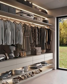 a walk in closet filled with lots of shoes and clothes hanging on the wall next to a sliding glass door