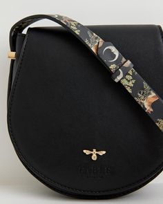 Our classic saddle bag has been given a seasonal update. The curved design evokes a sense of country life, reminiscent of a classic equestrian saddle bag but with a magical finish with the application of our A Night's Tale print to the strap. This compact cross-body, in midnight black certified vegan leather, is the perfect carrier to accompany you on your journey through your very own Night's Tale.
  Key features:
  Approx. 17 (L) x 18 (H) x 5 (D) cm
 Outer: 100% Vegan Leather; Lining: 100% Pol Equestrian Saddle, Swan Jewelry, Luxury Christmas Gifts, Twilly Scarf, Leather Saddle Bags, Black Cross, Midnight Black, Saddle Bag, Perfect Bag