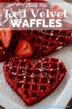 red velvet waffles with strawberries and powdered sugar in the shape of hearts