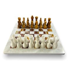 a marble chess board with white and brown pieces