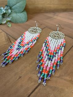 Hand beaded earrings with glass seed beads and Silver colored metal settings. Earring lengths are 5 inches long, including ear wires. Multicolor Beaded Chain Earrings For Summer, Summer Multicolor Beaded Chain Earrings, Multicolor Beaded Drop Earrings With Beaded Chain, Multicolor Heishi Beads Earrings With Ear Wire, Colorful Heishi Bead Dangle Earrings, Colorful Heishi Beaded Dangle Earrings, Hand Beaded Earrings, Green Tassel Earrings, Statement Piece Jewelry