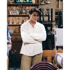 a man standing in a store with his arms crossed