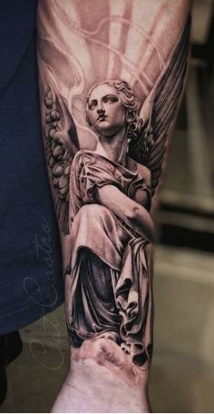 an angel tattoo on the arm