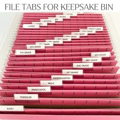 file tabs for keepsake bins are lined up in rows and labeled with labels