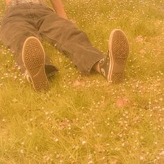 a person sitting in the grass with their legs crossed