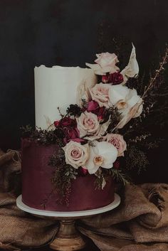 a white and red cake with flowers on top