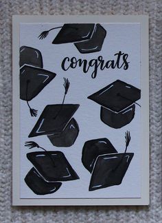 congratulations card with black graduation caps and tassels on white paper that says congrats