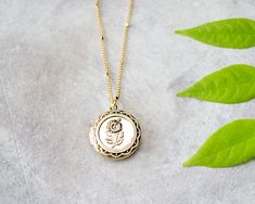 Lovely gold flower engraved locket pendant. Engraved Brass Medallion Charm Necklaces, Engraved Medallion Brass Charm Necklaces, Engraved Medallion Charm Necklace In Brass, Engraved Brass Medallion Charm Necklace, Dainty Locket Charm Necklace With Round Pendant, Dainty Medallion Locket Charm Necklaces, Dainty Medallion Locket Charm Necklace, Brass Medallion Necklace For Gift, Gift Locket Pendant Necklace