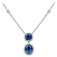 A timeless pendant necklace, showcasing two mixed-cut sapphires weighing 3.49 carats total, each set on a four prong setting. Accented by a halo of round cut diamonds weighing 0.58 carat total. Attached to a diamonds by the yard chain made of 18K white gold. Roman Malakov is a custom house, specializing in creating anything you can imagine. If you would like to receive a special quote on a custom piece, please message or call us. Diamonds By The Yard, Diamond Drop Pendant, Gold Drop Necklace, Diamond Drop Necklace, Diamond Bracelet Design, Vintage Pendant Necklace, Necklaces Pendant, Drop Pendant Necklace, Blue Sapphire Diamond