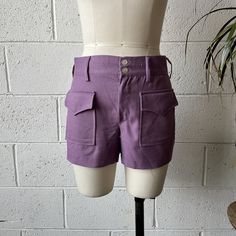 These 1970's vintage Trousers shorts are made from a pastel purple, rayon/cotton blend and feature a mid rise, bareback fit with a large, flap closure, cargo style pocket at either hip. Zips up in front with a Talon zipper to a double button closure at the waist. In excellent vintage condition with only minimal signs of wash and wear. No size listed, see below for measurements 30" waist 37" hips 9.5" rise 3.5" inseam Cheap Purple Shorts With Pockets, Fitted Shorts With Pockets And Short Leg, Fitted Shorts With Pockets, Retro Cargo Pocket Bottoms For Spring, Fitted Shorts With Patch Pockets, Cotton Shorts With Belt Loops, Fitted Cotton Shorts With Side Pockets, Fitted Shorts With Pockets And Short Inseam, High Waist Cotton Shorts With Hip Pockets