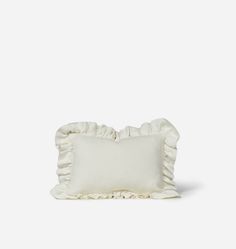 a white pillow with ruffled edges