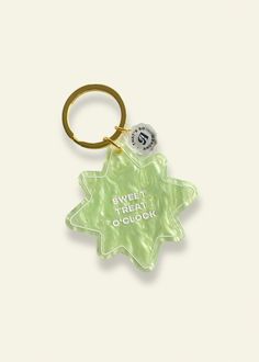 a green keychain with the words, sweet treat o'clock on it