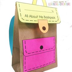 a brown paper bag with a pink pocket on the front and yellow tag hanging from it