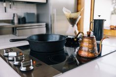 a black pan sitting on top of a stove