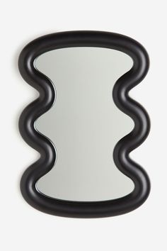 a mirror that is on the wall with wavy lines around it and an oval shape in the middle