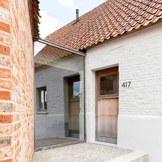 a brick building with a wooden door and window