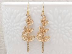 "The lovely and unique woodland inspired leaf earrings. They feature beautiful textured golden leaves growing along the branch. They hang underneath golden plated French ear wires. The earrings measure about 51mm (2 inches) from the top of the ear wire to the bottom of the leaf branch. A wonderful idea for gift giving or as a little treat for yourself. Your item will arrive in gift wrap and ready to gift. Measurements and details: Length: approximately 51mm (2\") Leaf: 41mm x 16mm Earwires: gold Gold Twigs, Swarovski Pearl Necklace, Silver Hair Clip, Branch Earrings, Gold Leaf Earrings, Boho Modern, Woodland Forest, Golden Leaves, Vintage Style Jewellery