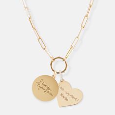 two heart shaped pendants on a chain with the words i love you more than me