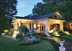 a white house with lights on the front porch