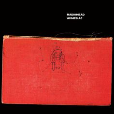 an old red book with black writing on the front and back cover that has a drawing of a robot in it