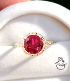 a close up view of a ring with a red stone in it's center