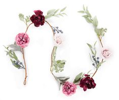 flowers arranged on top of each other in the shape of a letter o with leaves and branches