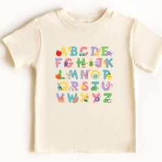 Head back to school in style while learning your letters and letter sounds in this super cute ABC tee! Uplift any child's wardrobe with a custom kid's t-shirt. The Bella Canvas short sleeve tee for toddlers is a 100% Airlume combed and ring-spun cotton jersey with a tear-away label for extra comfort. Choose your favorite color out of a big variety, and make unique staples that toddlers will happily wear every day.  .: 100% airlume combed and ring-spun cotton (fiber content varies for different c Playful T-shirt For Back To School, Playful Funny Print T-shirt For School, Multicolor Letter Print T-shirt For School Events, Cute Letter Print T-shirt For Playtime, Cotton Short Sleeve T-shirt For Playdate, Cute Cotton T-shirt For Playdate, Cotton Tops For Playtime And Back To School, Casual Tops For Back To School Playtime, Fun Letter Print T-shirt For End Of School Year