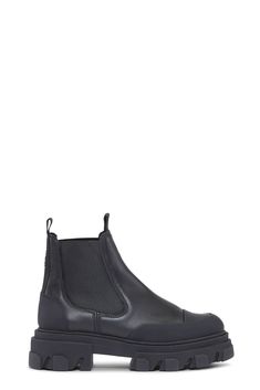 Signature GANNI low leather chelsea boots with super chunky, ribbed rubber soles, elasticated and toe caps. <br><br><ul> <li>Hit low just at ankle </li> <li>Runs small to size, take a size up for a more comfortable fit.</li> <li>Pronounced rubber welts</li> <li>Round toe</li> <li>Subtle GANNI logo at back ankle</li> <li>Front and back pull tabs</li> <li>Slip on chelsea-style with elastic panels</li> <li>100% leather upper with rubber soles</li> <li>Made in Portugal</li> </ul> Floral Bags, Super Chunky, Leather Chelsea Boots, Crossbody Tote, Chelsea Boot, Small Gifts, Chelsea Boots, Dress Shop, Chelsea