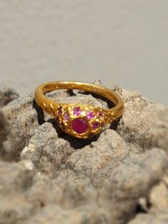 This is a goldfilled designer delicate  handmade ring which has a simple  minimalist design. The ring is set with 22-25 rubies gems.-Listing is for one ring-14 karat goldfilled -22-25 rubies -Free shipping worldwide-All my jewelry come in a gift boxI can also make this ring with your favorite gemstone or birthstone, choose from: blue topaz, garnet and smoky quartz. I can make this ring in silver, goldfilled for the same price, or solid gold by request.If you have another gem in your mind let me Minimalist Gold Ruby Ring, Dainty Ruby Ring With Rose Cut Diamonds For Promise, Dainty Ruby Ring With Rose Cut Diamonds, Dainty Round Ruby Ring, Dainty Ruby Gemstone Stackable Rings, Gold Ruby Open Ring Birthstone, Elegant 22k Gold Ruby Ring Gift, Gold Ruby Birthstone Ring With Rose Cut Diamonds, Gold Ruby Birthstone Open Ring