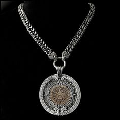 "This piece features my huge 3\" (76mm) antique silver finish Aztec Calendar Stone design medallion with an antique bronze centerpiece on a double-strand antique braided chain with eagle wings ends. It will catch every eye within 50 feet and be the source of many conversations. The look and feel of our necklace upon the first touch will speak to you immediately of hand-crafted quality. It makes a stunning accessory - appropriate for all ages, men or women - all will love it. It includes a black Luxury Silver Medallion Necklace, Luxury Silver Engraved Medallion Necklace, Luxury Engraved Silver Medallion Necklace, Silver Coin-shaped Medallion Necklace, Antique Silver Medallion Jewelry With Antique Finish, Silver Medallion Necklace, Bronze Centerpiece, Aztec Jewelry, Love Warriors