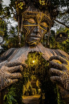 a large statue made out of wood and plants