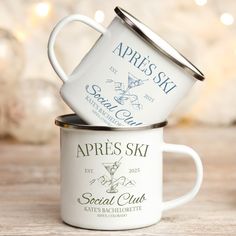 two coffee mugs stacked on top of each other with the words appress ski printed on them