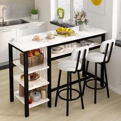 a kitchen island with two stools next to it