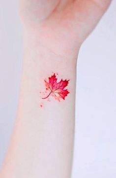 a red maple leaf tattoo on the wrist