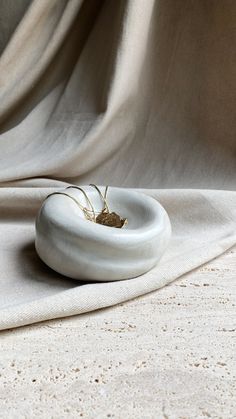 a white object sitting on top of a cloth covered floor