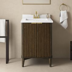 a bathroom with a sink, mirror and towel rack in it's corner next to a chair